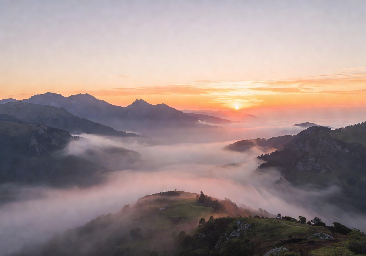Peaceful morning sunrise over calm misty mountains